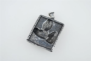 Macro detail of a vintage steampunk plague doctor pendant with flying bird relief design