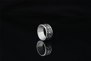 Macro detail of vintage Egyptian Eye of Horus and Ankh symbols on a titanium steel ring