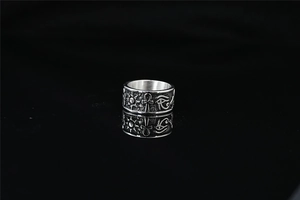 Detailed macro view of vintage stainless steel ring with engraved Egyptian Ankh cross symbols