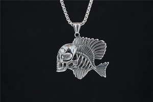 Macro detail of gothic fish skeleton skull pendant in silver polished metal finish