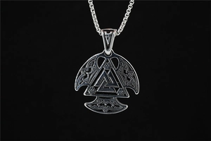 Detailed view of vintage silver Valknut pendant with intricate Nordic engravings