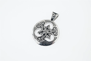 Macro view of vintage stainless steel Celtic knot round pendant with intricate woven details