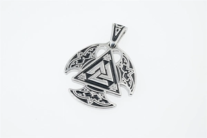 Macro detail of silver Valknut pendant with blackened Norse runes and Viking patterns