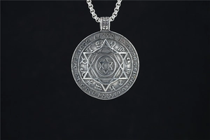Close-up of vintage stainless steel Viking hexagram pendant with twelve zodiac symbols