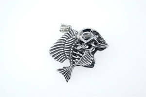 Detailed view of punk style silver fishbone skeleton pendant with gothic skull design