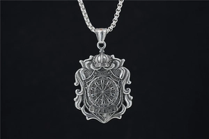 Detailed close-up of shield-shaped darts pendant with crown on silver box chain