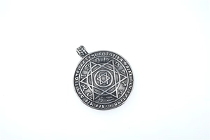 Macro shot of Viking hexagram circular pendant with zodiac signs and vintage finish