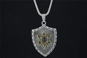 Detail of shield-shaped pendant with golden hexagram and black bead on steel chain