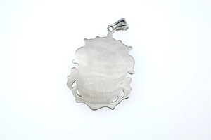 Macro detail of silver crown pendant back with brushed steel finish and scalloped edges