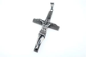 Macro view of vintage titanium steel crucifix pendant with relief Jesus sculpture