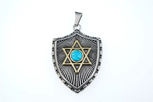 Macro detail of star of david shield pendant with turquoise inlay and radial texture
