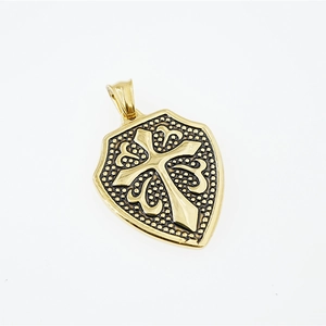 Golden shield cross pendant necklace in stainless steel with retro scroll texture details
