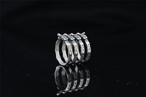 Macro detail of silver titanium steel ring with oxidized gothic rib bone texture