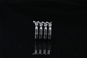 Close-up of gothic titanium steel rib cage ring with distressed rock texture and dark finish