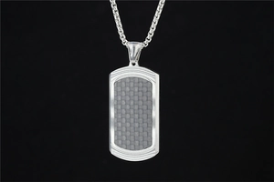 Close-up of silver dog tag pendant featuring a grey carbon fiber texture on a box chain