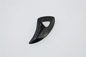Macro shot of polished black fang pendant with glossy finish and top perforation