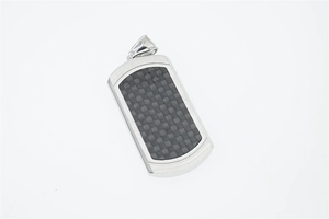 Detail of military dog tag pendant with carbon fiber inlay and stainless steel frame