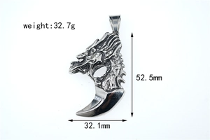 Detail showing dimensions of a vintage steel wolf tooth dragon pendant, 52.5mm by 32.1mm