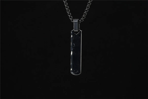Macro detail of gunmetal rectangle pendant necklace with industrial box chain style