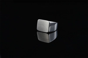 Detailed view of square signet ring showing brushed top surface and polished side finish