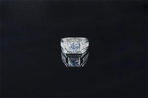 Macro shot of wide silver ring with large round moissanite and pave diamond setting