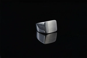 Macro detail of men's titanium steel square ring with brushed top and polished sides
