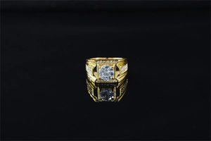 Detailed view of luxury gold-plated ring featuring a large round moissanite and pave stones