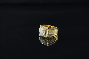 Close-up of luxury gold-plated men's ring with large round moissanite and pave stones
