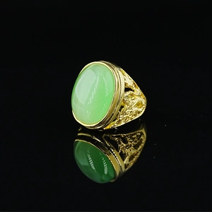 Vintage Chinese style hollow dragon ring with gold finish and green cat-eye stone