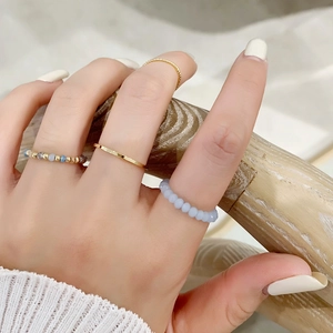 4-piece set of gold rings with light blue crystal beads for stylish stacked look