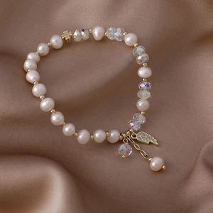 Baroque freshwater pearl bracelet with crystal beads and zircon wing pendant on silk