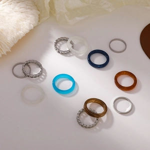 Flat lay of acrylic resin ring set including chain and colorful translucent bands