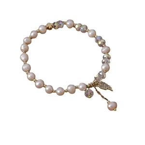 Elegant freshwater pearl and crystal bead bracelet featuring a golden clover and palm charm