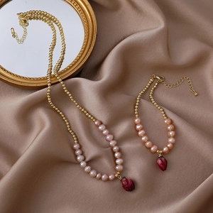 Elegant floral necklace and bracelet set with red dried flowers on champagne silk fabric