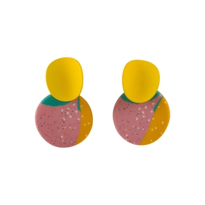 Detail of handmade abstract clay earrings with yellow and multicolor geometric patterns
