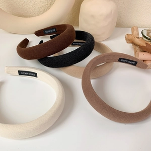 Macro view of five solid color thick sponge headbands with textured cotton linen fabric