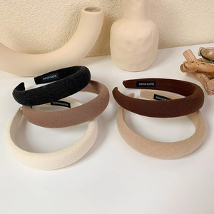 Macro view of thick sponge headbands with fabric texture and Hand Made label detail