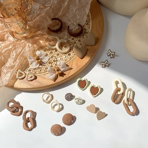 Vintage caramel brown stud earring set with heart and bow designs in earthy resin