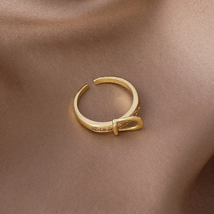 Gold belt buckle open ring for women with micro-set zircons on elegant silk background