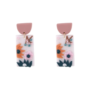 Detail of floral relief on handmade polymer clay drop earrings with colorful 3D blossoms