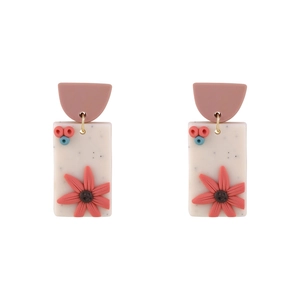 Detail of retro floral resin drop earrings with pink semi-circles and white rectangles