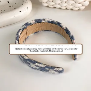 Detail of tweed headband interior showing elastic structure and soft brown lining
