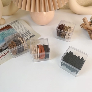 Neutral coffee tone seamless elastic hair ties set in a transparent acrylic storage box