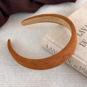 Vue détaillée d'un serre-tête épais caramel avec doublure antidérapante sur des livres