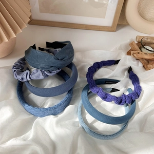 Detail shot of varied Klein blue headbands showing leather, satin and knit textures