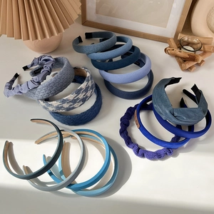 Macro view of blue padded sponge headbands and woven hair hoops in various textures