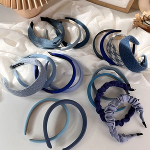 Macro shot of various blue padded headbands showing knitted and pleated fabric textures
