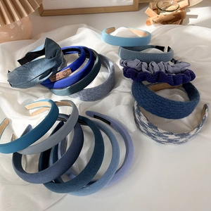 Klein blue padded headbands set in various textures like knit, satin and faux leather