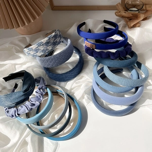 Collection of blue padded headbands in velvet and knit textures for hair styling