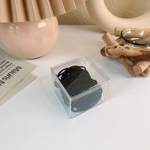 Detailed view of elastic hair ties neatly stored in a clear acrylic organizer box